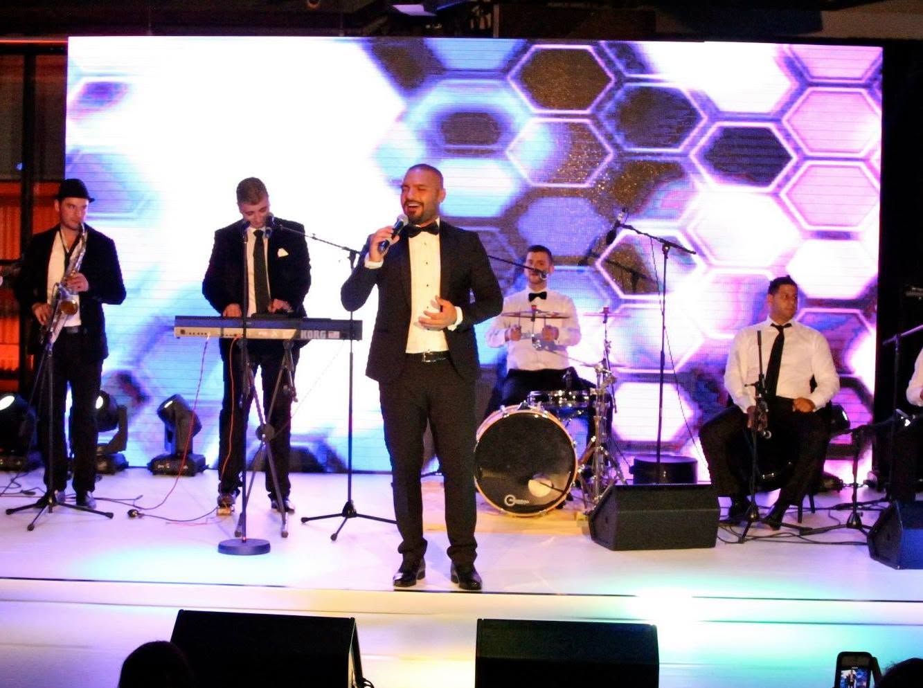 The AMW band backing a vocalist on stage